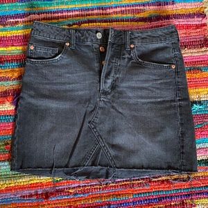 Distressed black denim skirt